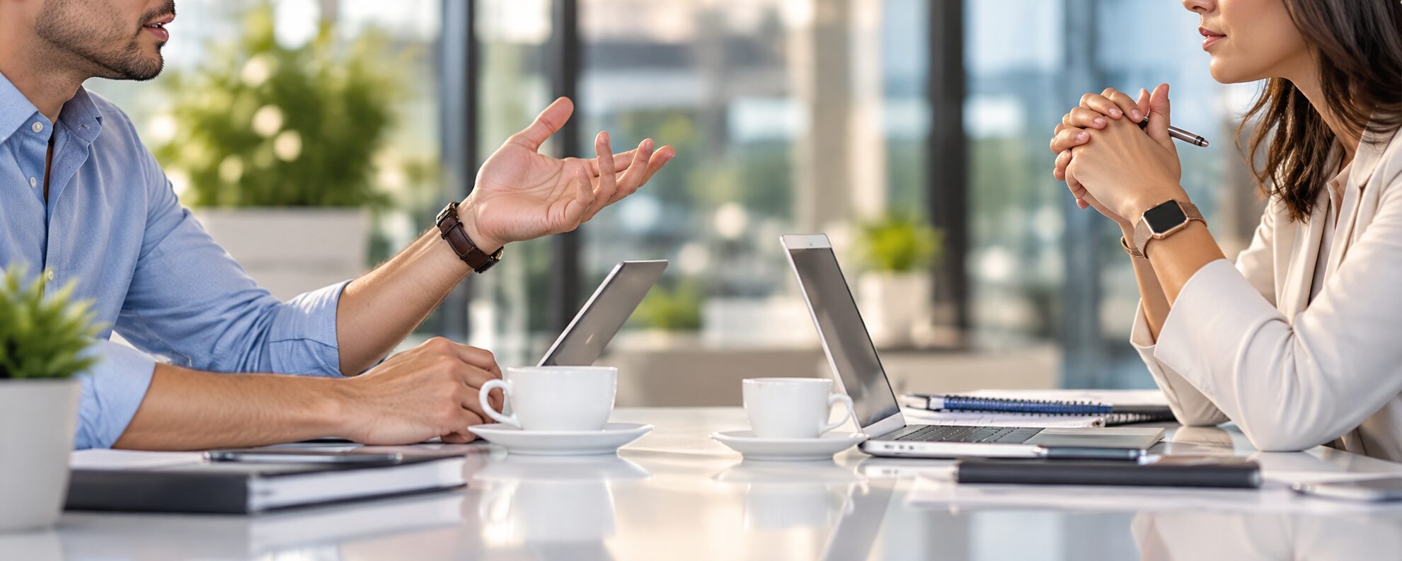 Two business professionals in conversation at a meeting table